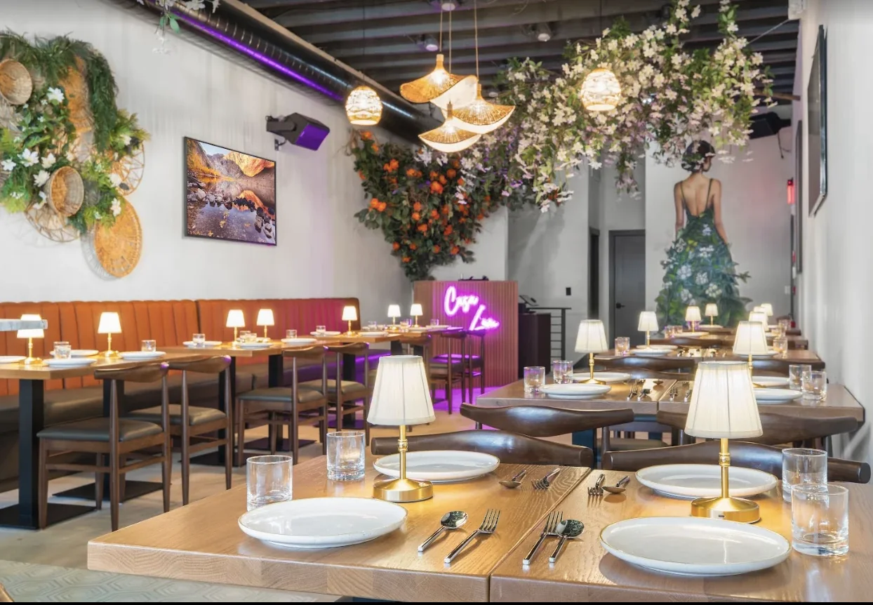 The Casa Lum dining room with rattan lanterns, a floral canopy and gold table lamps